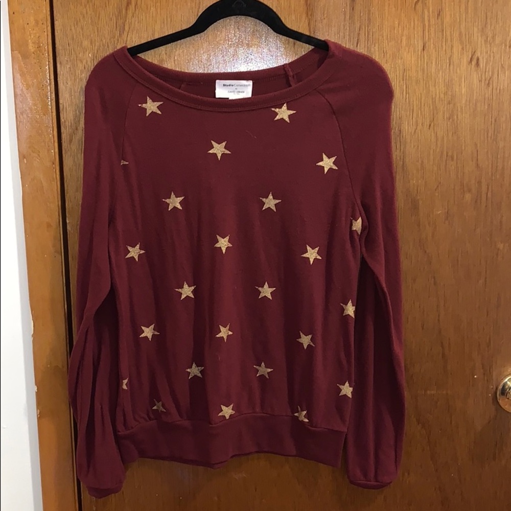 dark red sweater with gold stars
